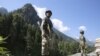 Indian paramilitary soldiers stand guard on a highway leading to Ladakh, India in the territory of Kashmir on June 17, 2020, two days after a bloody border clash with Chinese soldiers. 