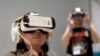 FILE - A woman uses Samsung Gear VR during the Mobile World Congress, the world's largest mobile phone trade show in Barcelona, Spain, March 2, 2015.