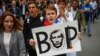 A protester carries a poster reading "Thief" and depicting Russian President Vladimir Putin during a rally against planned increases to the nationwide pension age in St. Petersburg, Russia September 9, 2018. REUTERS/Anton Vaganov