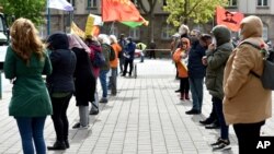 Demonstrators practice social distancing due to coronavirus restrictions, at a Labor Day rally in Duisberg, Germany, May 1, 2020. 