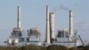 FILE- The Fayette Power Project, a coal-fired power plant, is shown in Ellinger, Texas, Dec. 15, 2010. Some environmentalists, ranchers and scientists linked tree deaths in the area to sulfur dioxide emissions from the plant.