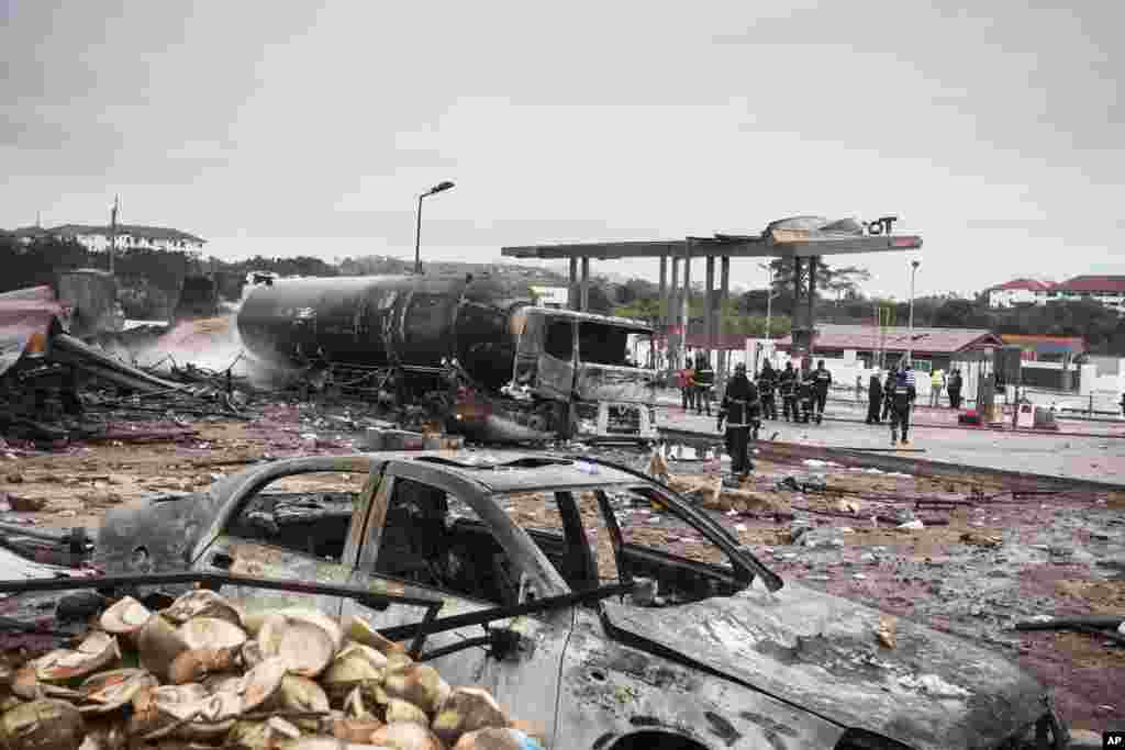 Firemen at the site of Saturday's gas tanker explosion in Accra, Ghana. Ghana's deputy information minister says a tanker explosion at a gas-filling station, followed by a secondary blast, has left a number of casualties in the Legon suburb in northwest Accra.