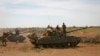 Somalia Al-Shabab's Resurgence: FILE - In this Wednesday, Feb. 29, 2012 file photo, Ethiopian military tanks sit in position on the outskirts of the town of Baidoa in Somalia. 