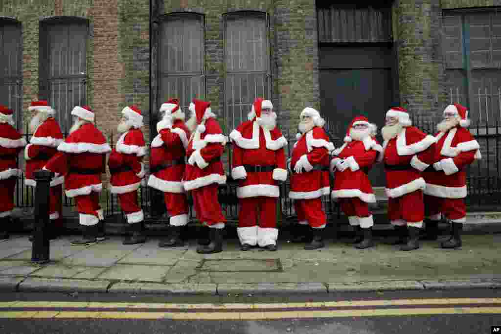 Performers dressed as Santa Claus stand in a line outside the Ragged School Museum in east London. The Ministry of Fun Santa School is Britain's only genuine training school for professional Santas, preparing them to help out in grottos, department stores, attractions and events over the Christmas period.