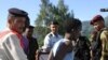An arrested Somali pirate is handcuffed by police upon his arrival in Port Victoria, 31 Mar 2010, with the six Seychellois fishermen, who were taken hostage by Somali pirates