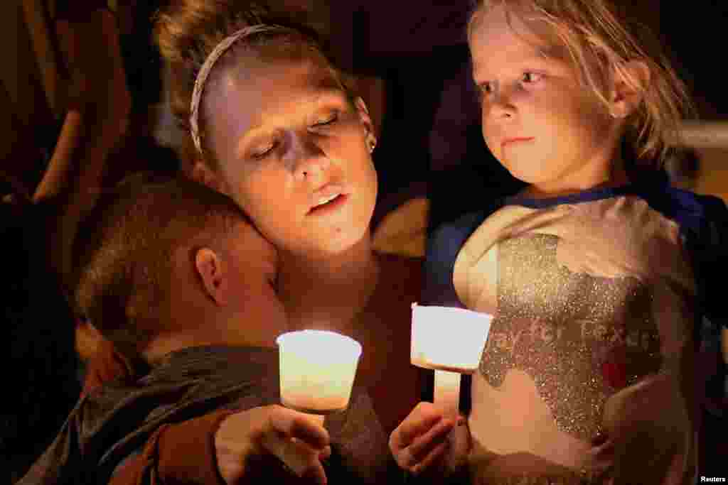 A woman and her children take part in a vigil for victims of a mass shooting in Sutherland Springs, Texas, Nov. 5, 2017.