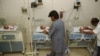 FILE - Pakistani hospital staff members attend newly born babies in Karachi, Pakistan.