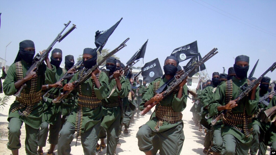FILE - Al-Shabab fighters march with their weapons during military exercises on the outskirts of Mogadishu, Somalia, Feb. 17, 2011. 