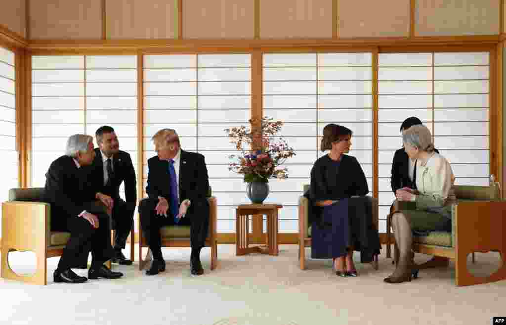 U.S. President Donald Trump talks with Japan's Emperor Akihito while his wife Melania talks with Empress Michiko at the Imperial Palace in Tokyo.