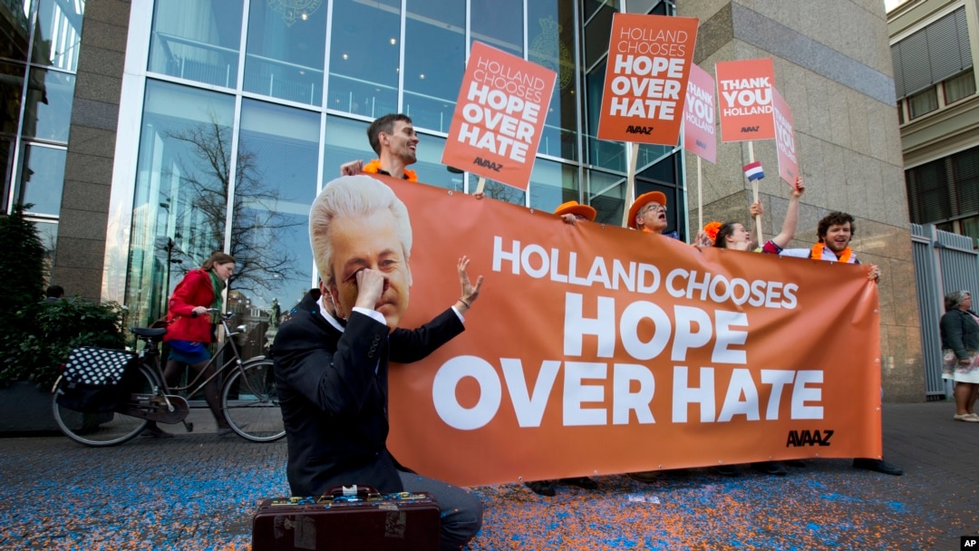 FILE - A man poses as crying firebrand anti-Islam lawmaker Geert Wilders during a small demonstration outside parliament, rear, in The Hague, Netherlands, March 16, 2017. 