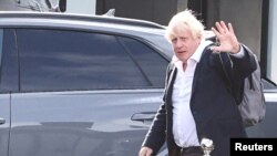 Former British Prime Minister Boris Johnson walks, at Gatwick Airport, near London, Britain, Oct. 22, 2022. 