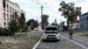 FILE PHOTO: A Ukrainian serviceman patrols a street next to damaged buildings in the town of Sudzha