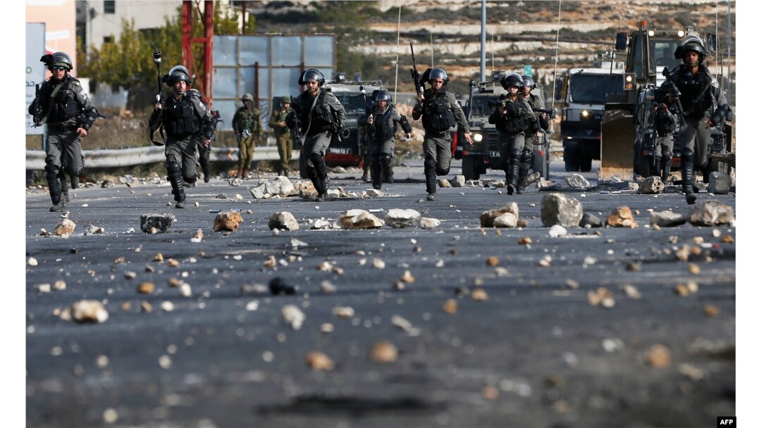 FILE - Israeli security forces clash with Palestinian protesters in the West Bank city of Ramallah, Dec. 11, 2017, as demonstrations continued to flare in the Middle East and elsewhere over U.S. President Donald Trump's declaration of Jerusalem as Israel's capital.