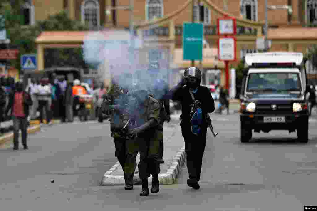 Riot policemen fire tear gas to disperse supporters of Kenyan opposition National Super Alliance (NASA) coalition during a protest along a street in Nairobi.
