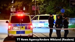 FILE - Police stand near the Israeli embassy after a suspected shooting nearby in Stockholm, Oct. 1, 2024. (TT News Agency/Anders Wiklund via Reuters)
