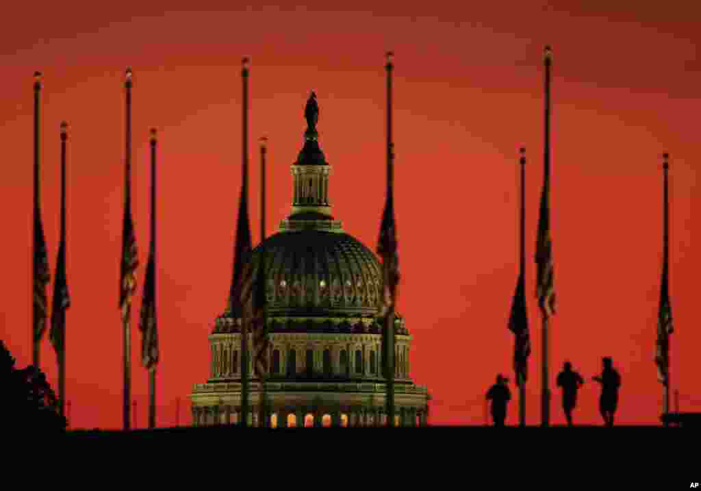 The U.S. Capitol dome backdrops flags at half-staff at the foot of the Washington Monument on the National Mall in Washington, in honor of the victims killed in the Las Vegas shooting.
