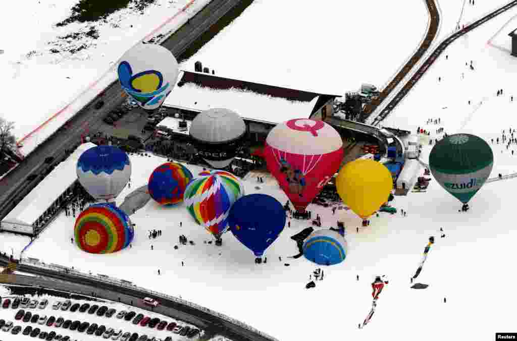 Balloons fly during the 41st International Hot Air Balloon Week in Chateau-d'Oex, Switzerland, Jan. 26, 2019.