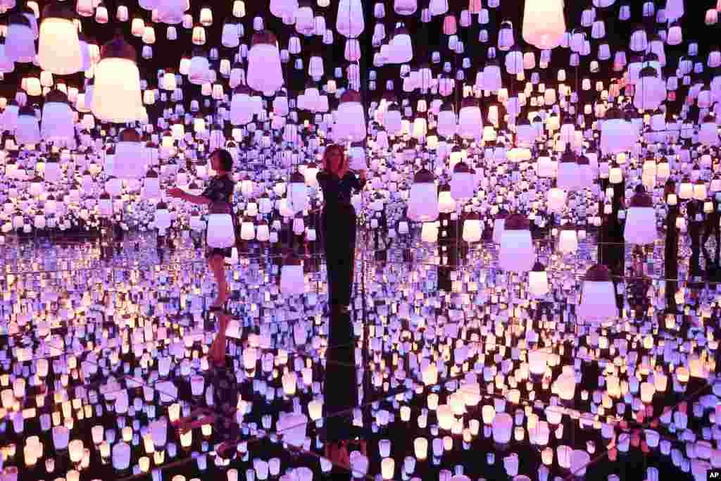 U.S. First Lady Melania Trump, right, and Japanese Prime Minister Shinzo Abe's wife Akie Abe visit a digital art museum in Tokyo.