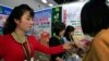 FILE - North Koreans look at products at an international trade fair held Sept. 25, 2017, in Pyongyang.