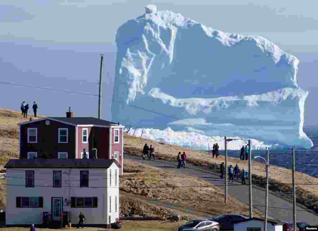 Residents view the first iceberg of the season as it passes the South Shore, also known as "Iceberg Alley", near Ferryland Newfoundland, Canada, April 16, 2017.