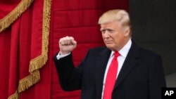 President-elect Donald Trump pumps his fist as he arrives during the 58th Presidential Inauguration at the U.S. Capitol in Washington, Jan. 20, 2017.
