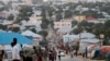 FILE -- People walk along a street in Mogadishu in Sept. 28, 2013. Elections are scheduled for October and November, but officials fear they may be delayed.