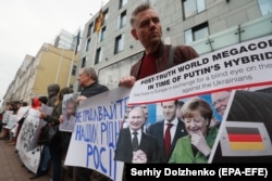 UKRAINE -- Relatives of Ukrainians who were captured and sentenced by Russia, hold placards with their portraits during a rally in front of German embassy in Kyiv, April 11, 2019