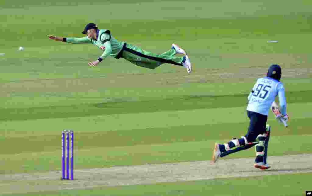 Ireland's Harry Tector, left, dives to make a catch but misses, during the third One Day International cricket match between England and Ireland, at the Ageas Bowl in Southampton, England.
