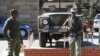 FILE - Army personnel are seen outside the military headquarters in Maseru, Lesotho, Aug. 31, 2014.