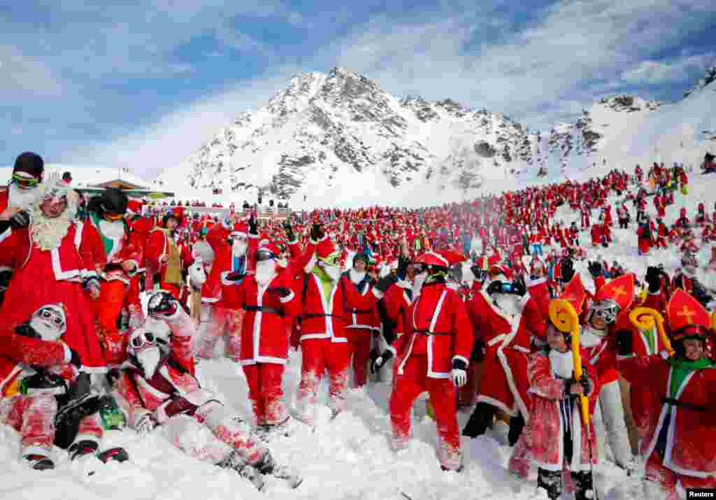 People dressed as Santa Claus enjoy the snow during the Saint Nicholas Day at the Alpine ski resort of Verbier, Switzerland, Dec. 2, 2017.