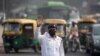 A traffic policeman wears a mask to protect himself from air pollution at a junction during restrictions on private vehicles based on registration plates, on a smoggy morning in New Delhi, India, November 4, 2019. REUTERS/Danish Siddiqui
