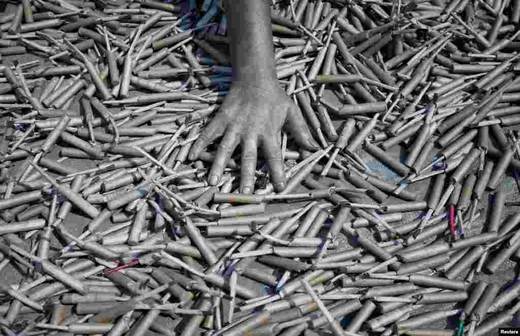 A worker checks the dryness of firecrackers at a factory ahead of Diwali, the Hindu festival of lights, on the outskirts of Ahmedabad, India.