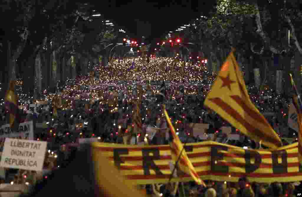People gather to protest against the National Court's decision to imprison civil society leaders without bail, in Barcelona, Spain, Oct. 17, 2017.