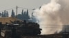 An Israeli soldier sits on top of a tank at a camp near the Israel-Gaza border, in Israel, Jan. 12, 2025. 