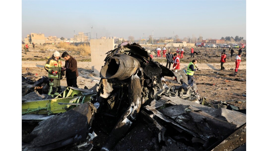 FILE - Debris is seen from an Ukrainian plane which crashed as authorities work at the scene in Shahedshahr, southwest of the capital Tehran, Iran, Jan. 8, 2020.