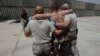 FILE - A U.S. Marine wounded in an IED attack, having been evacuated from the battlefield by the 101st Airborne, in an IED attack, is helped into the trauma bay at an advanced U.S. military field hospital at Forward Operating Base Dwyer, in southern Afgha