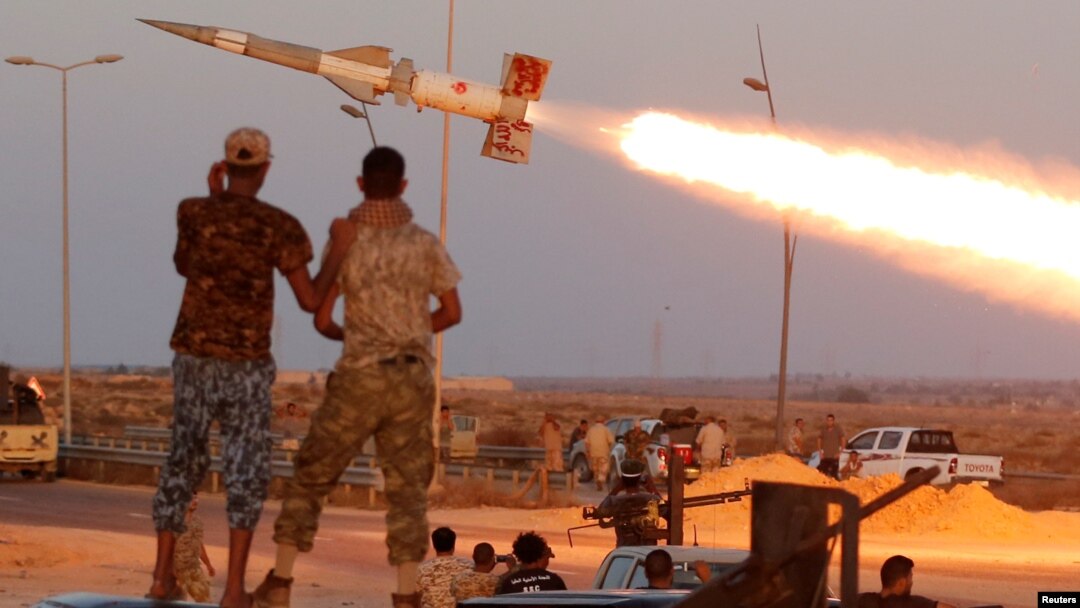 Fighters of Libyan forces allied with the U.N.-backed government fire a rocket at Islamic State fighters in Sirte, Libya, Aug. 4, 2016. 
