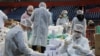 Volunteers help pack boxes of donated aid for elderly people who are banned from leaving their homes because of the coronavirus epidemic in Belgrade, Serbia, March 26, 2020.
