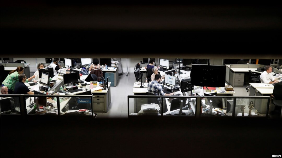 FILE - Journalists of Folha de S. Paulo newspaper work inside the editorial office of the newspaper in Sao Paulo, Brazil, Oct. 31, 2018. 