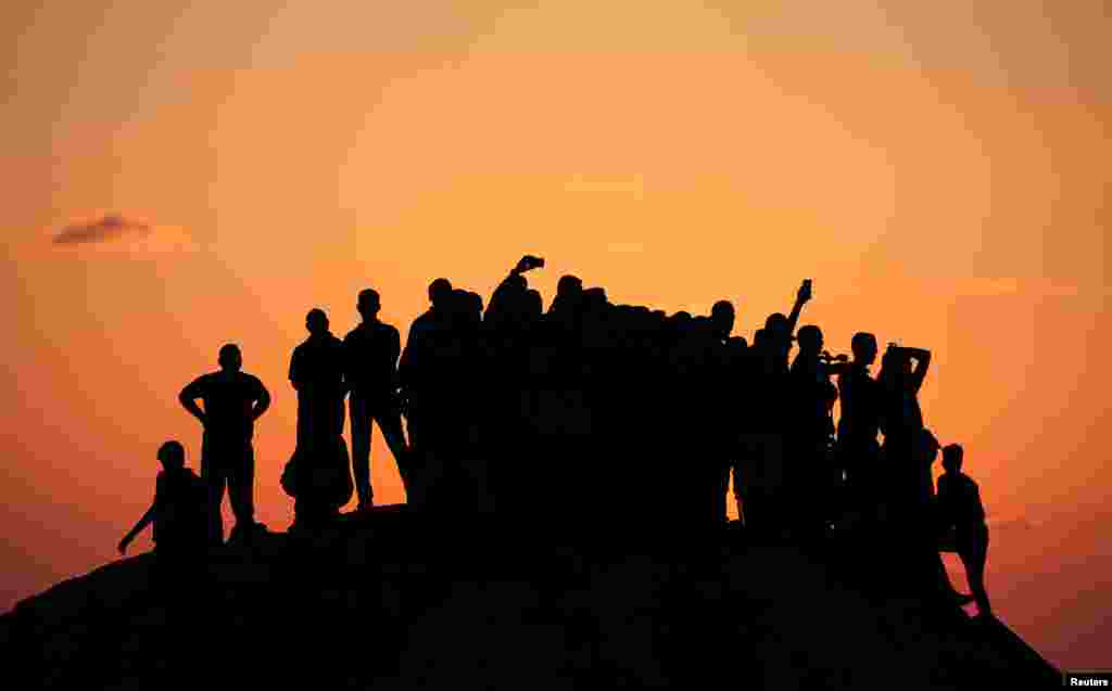 Palestinian demonstrators gather atop a hill in the northern Gaza Strip during a protest calling for lifting the Israeli blockade on Gaza.