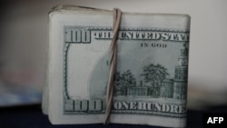 FILE - A view of U.S. dollar bills