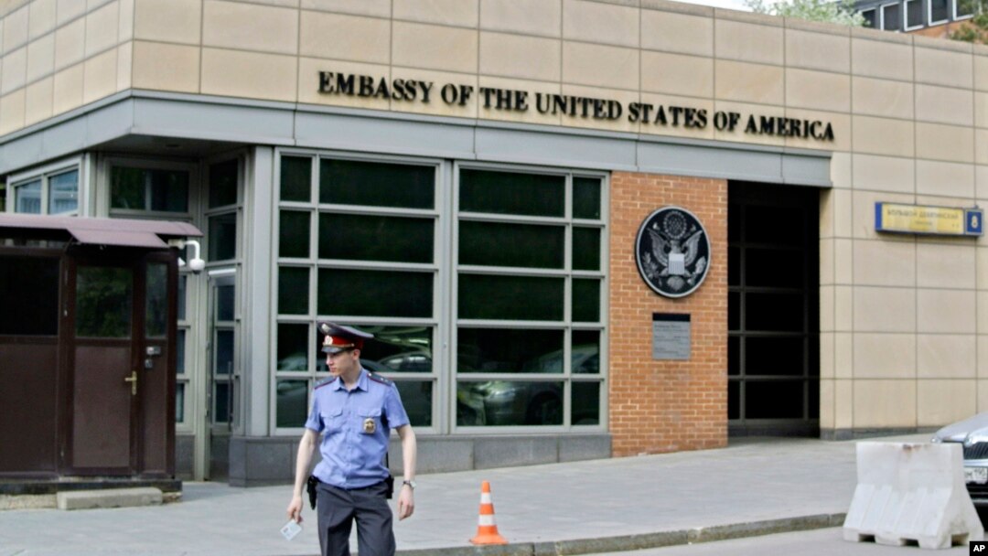 A Russian policeman stands in front of an entrance of the U.S. Embassy in the background in downtown Moscow, Russia, on May 14, 2013. 