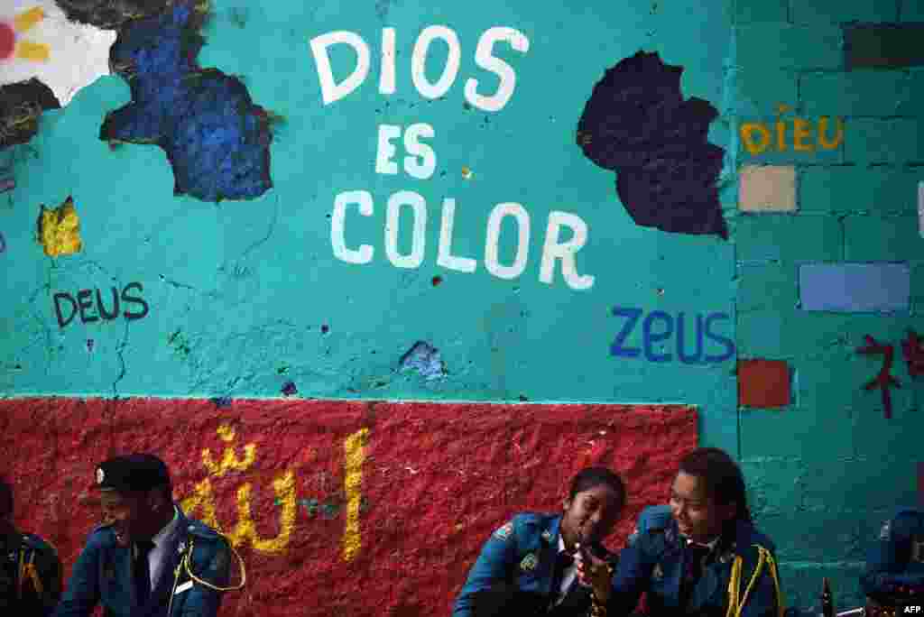 Students rest before taking part in a parade to commemorate the 114th anniversary of Panama's independence from Colombia, in Panama City, Panama.