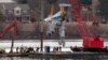 Rescue and salvage crews with cranes pull up the wreckage of an American Airlines jet in the Potomac River from Ronald Reagan Washington National Airport, Feb. 3, 2025, in Arlington, Va.