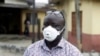 A man wearing a face mask walks outside Yaba Mainland hospital where an Italian citizen - the country's first case of the COVID-19 virus - is being treated, in Lagos, Nigeria, Feb. 28, 2020. 