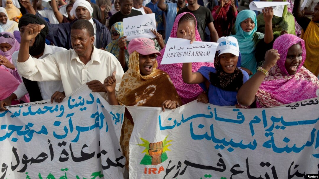 FILE - Mauritanian anti-slavery protesters march to demand the liberation of imprisoned abolitionist leader Biram Ould Abeid in Nouakchott, May 26, 2012.