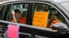 Motorists take part in a caravan protest in front of Senator John Kennedy's office at the Hale Boggs Federal Building asking for the extension of the $600 in unemployment benefits to people out of work because of the coronavirus in New Orleans, La.