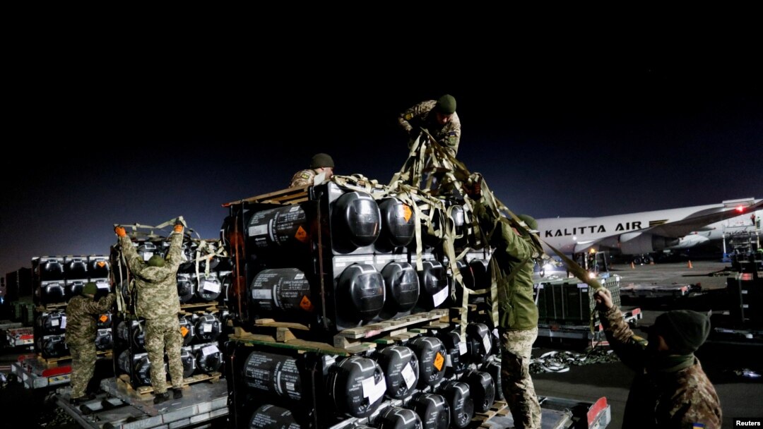 Ukrainian service members unpack Javelin anti-tank missiles, delivered by plane as part of the US military support package for Ukraine, at the Boryspil International Airport outside Kyiv, Ukraine, Feb. 10, 2022. 
