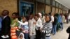 People queue to withdraw cash outside a bank in Harare, Zimbabwe, Nov. 28, 2017.