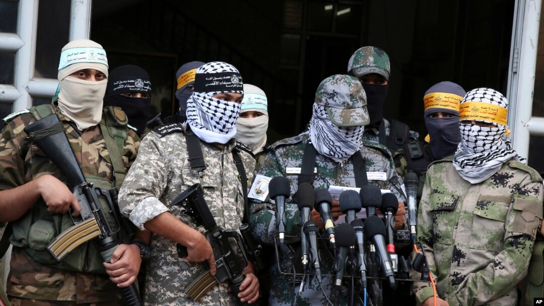 FILE - Masked Palestinian militants from Al Aqsa Martyrs' Brigade, a militia linked to the Fatah movement, give a press conference to condemn the decision by U.S. President Donald Trump to recognize Jerusalem as Israel's capital, in Gaza City, Dec. 7, 2017.
